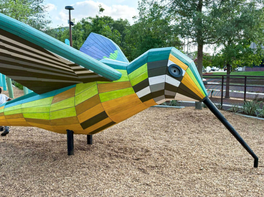 A colorful hummingbird play structure at Camden Park