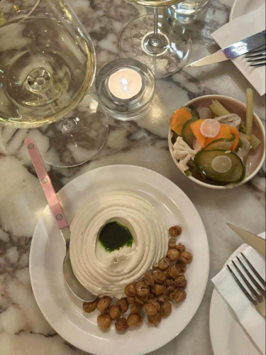 A plate with smooth and creamy hummus with crispy chickpeas