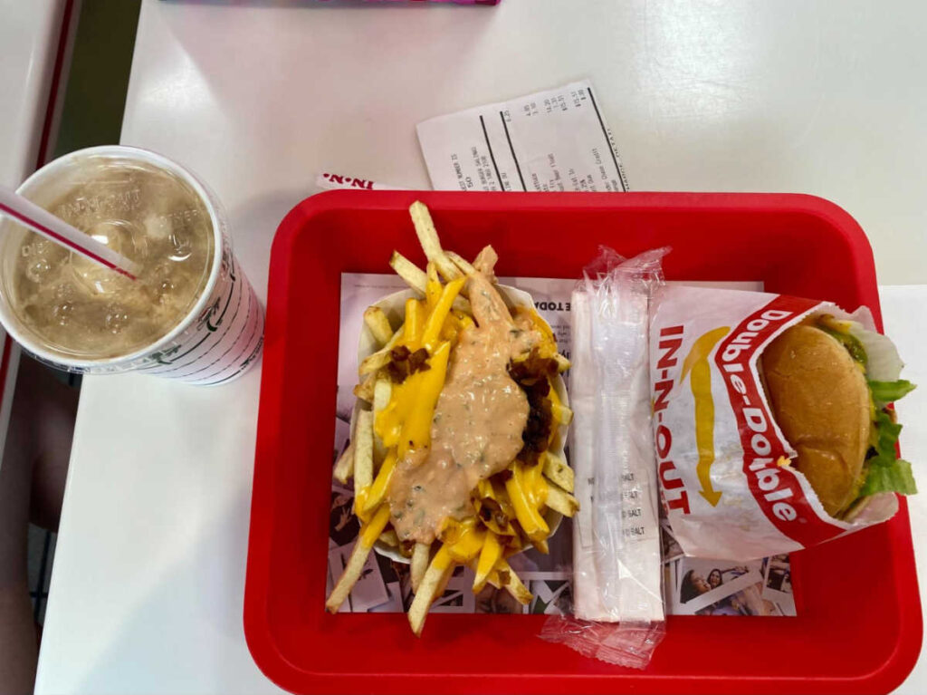 A tray with animal fries, double-double cheeseburger and a root beer float from In-N-Out