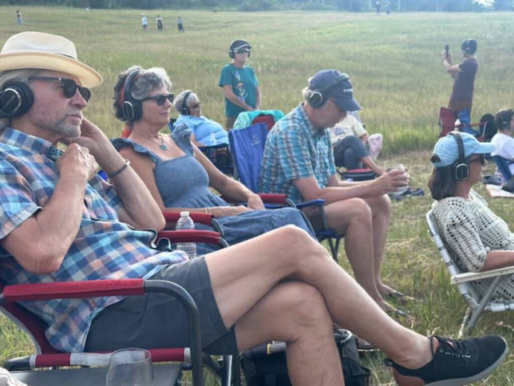 The attendees sitting and enjoying In a Landscape Concert
