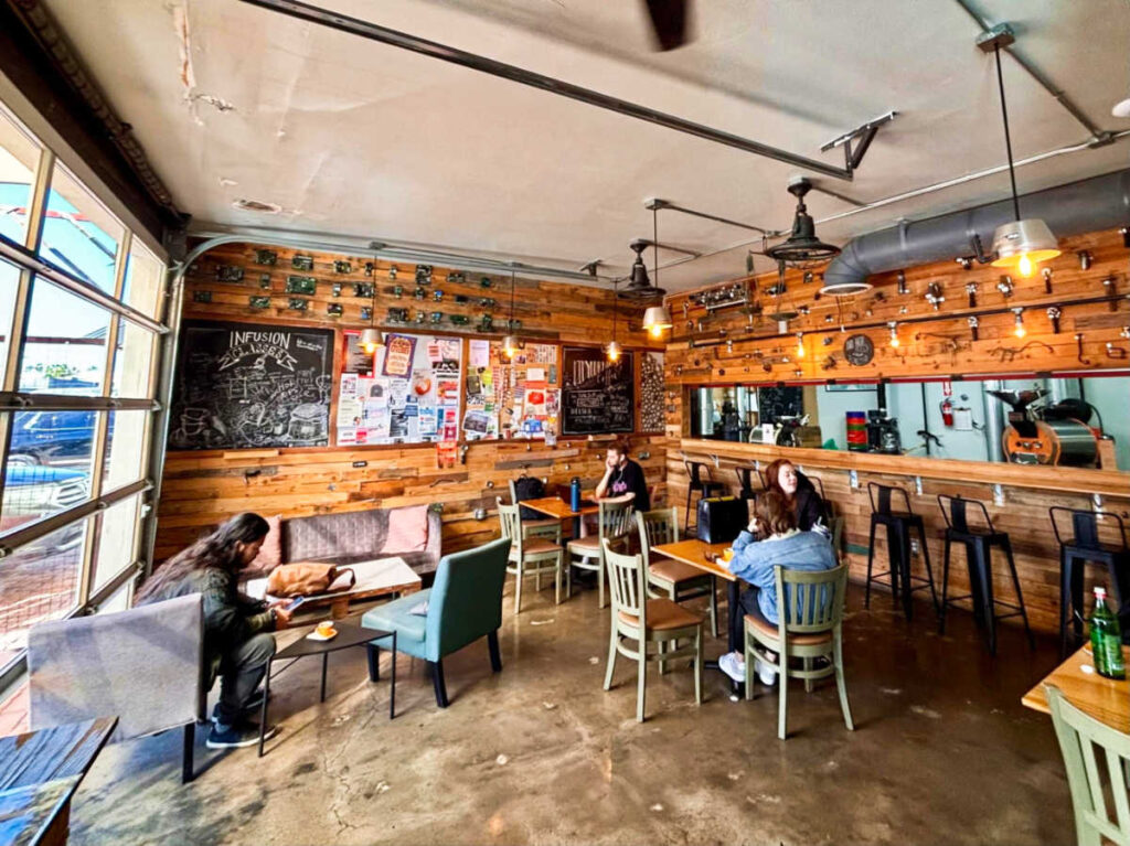 People inside the cozy interior of Infusion Coffee & Tea Crafters
