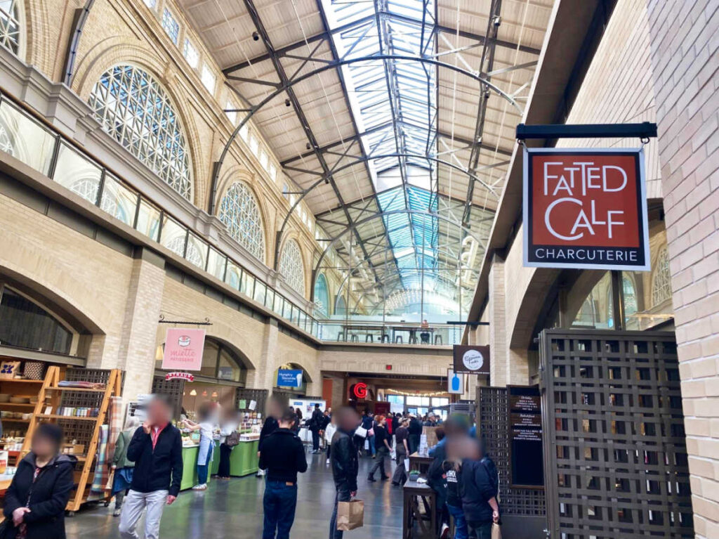 People wandering at the Ferry Building with shops and restaurants around