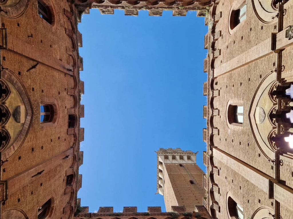 View of the clear blue sky from the inside of the Palazzo Pubblico