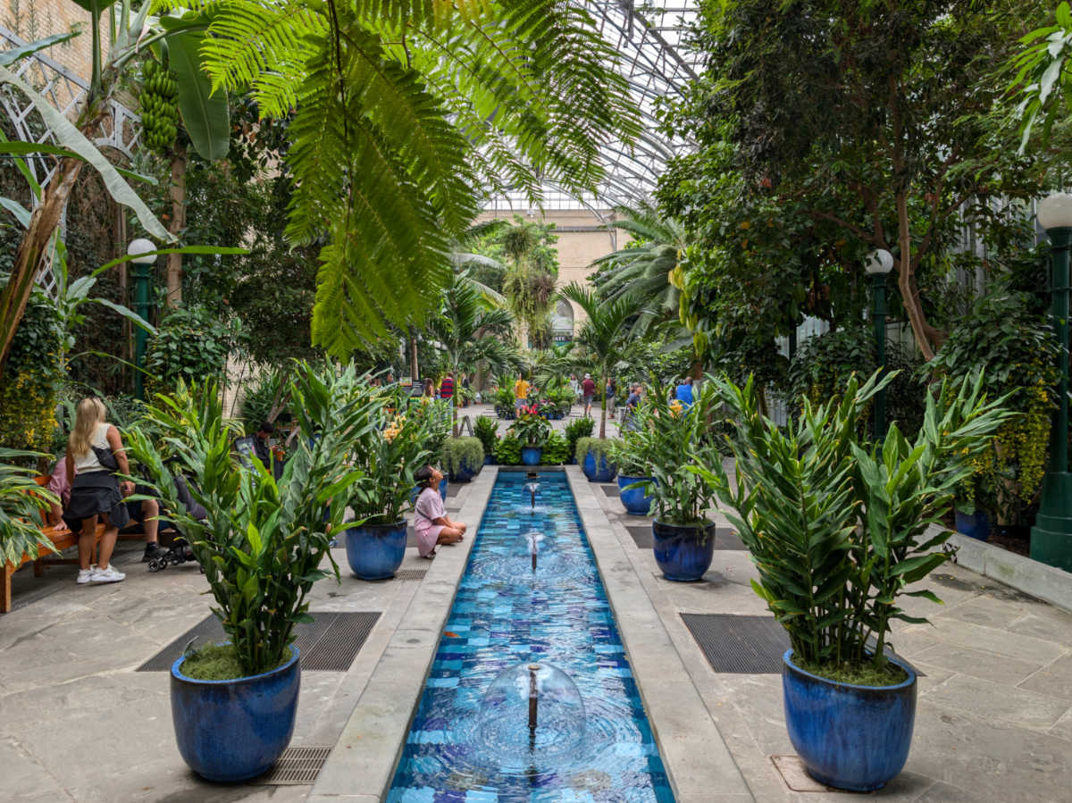 View of the people looking at the greenery and the waterway inside the United States Botanic Garden