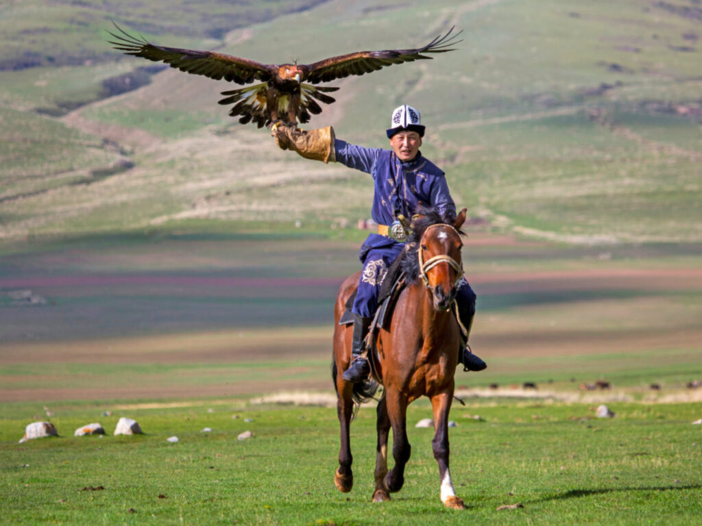 A hunter riding a horse and with a Golden Eagle on his hand