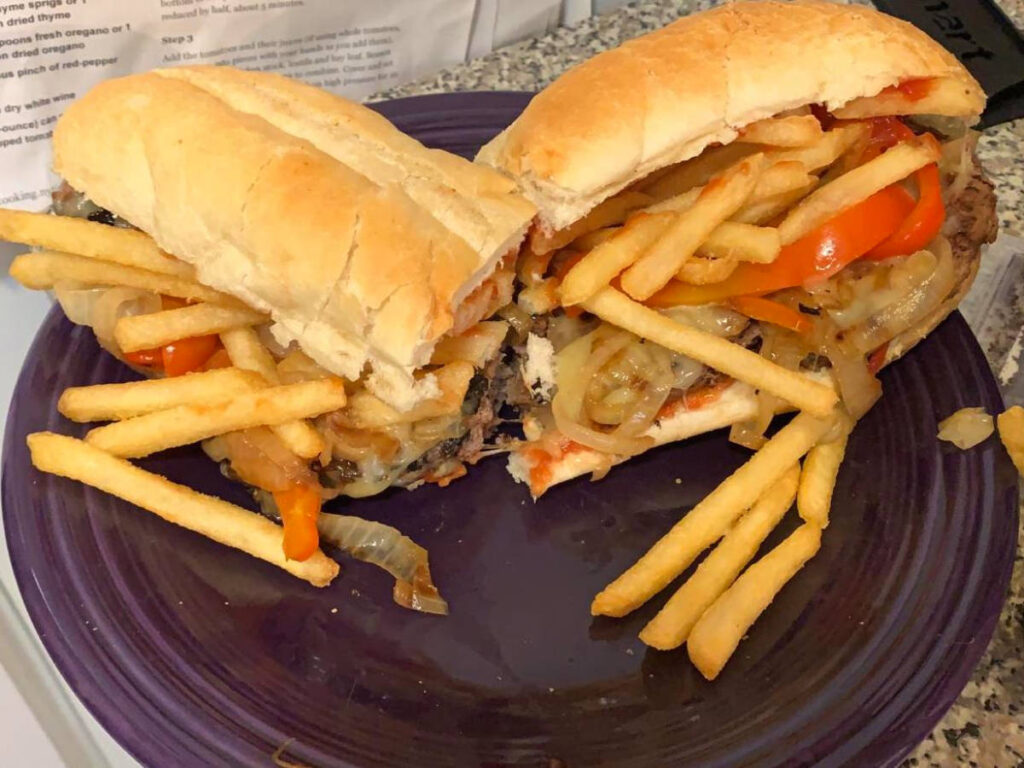 A plate of Italian Cheeseburgers cut in half