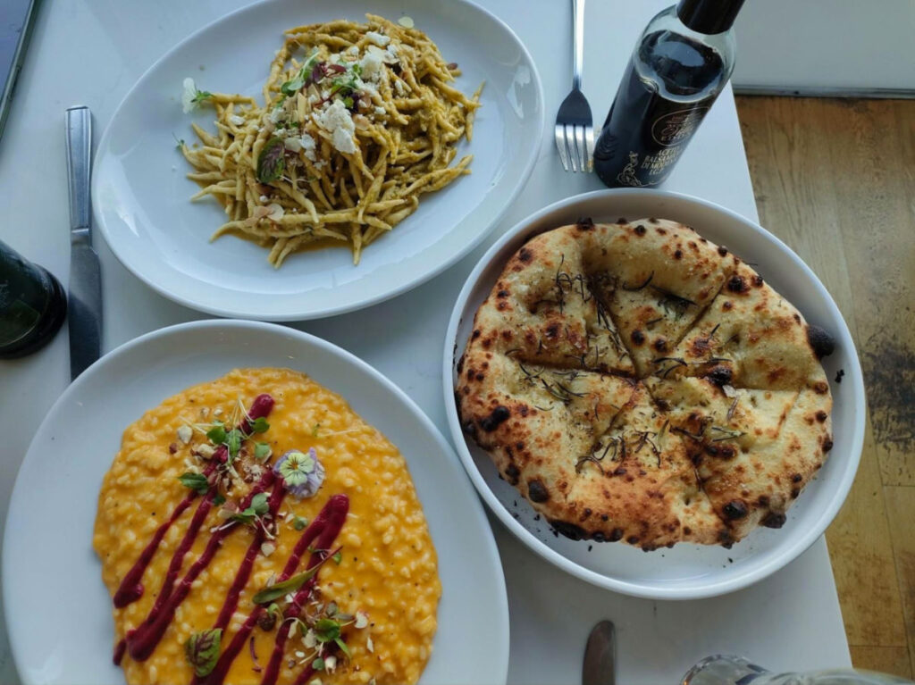 Plates of Santa Lucia’s finest focaccia, trofie pesto Siciliano, and risotto with roasted butternut squash