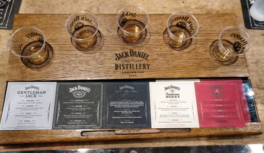 A board with glasses of whiskey with their information at the Jack Daniel Distillery
