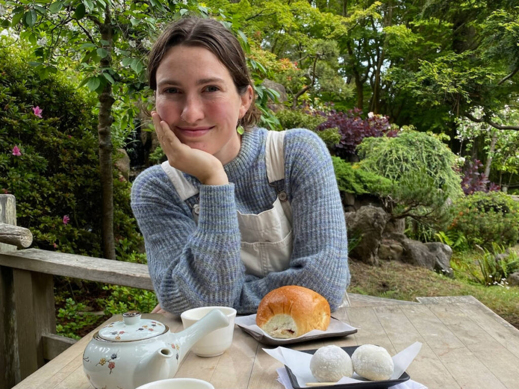 The author, Laura McFarland smiling for a photo in a Japanese Tea Garden