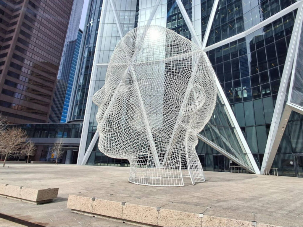 View of the “Wonderland” art installation by Jaume Plensa at The Bow