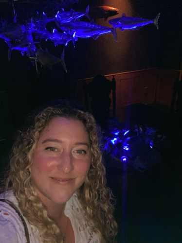 The author Jess Levy inside the dark room with illuminating lights in Elementa