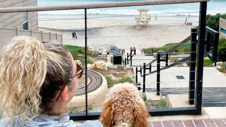 The author and her dog with a view of a beach in Carlsbad