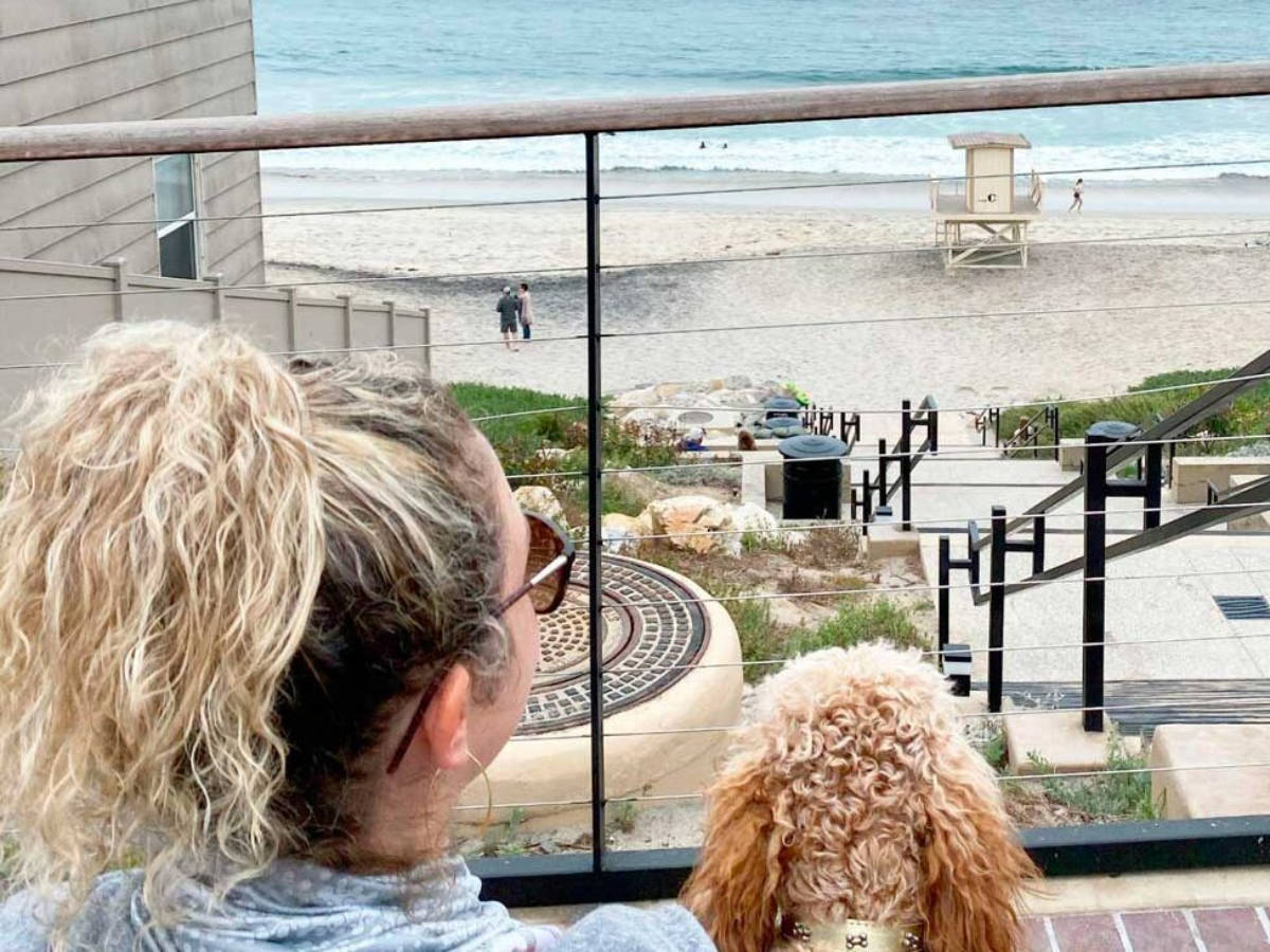 Travel Lemming Jess Levy with her dog looking at the beach