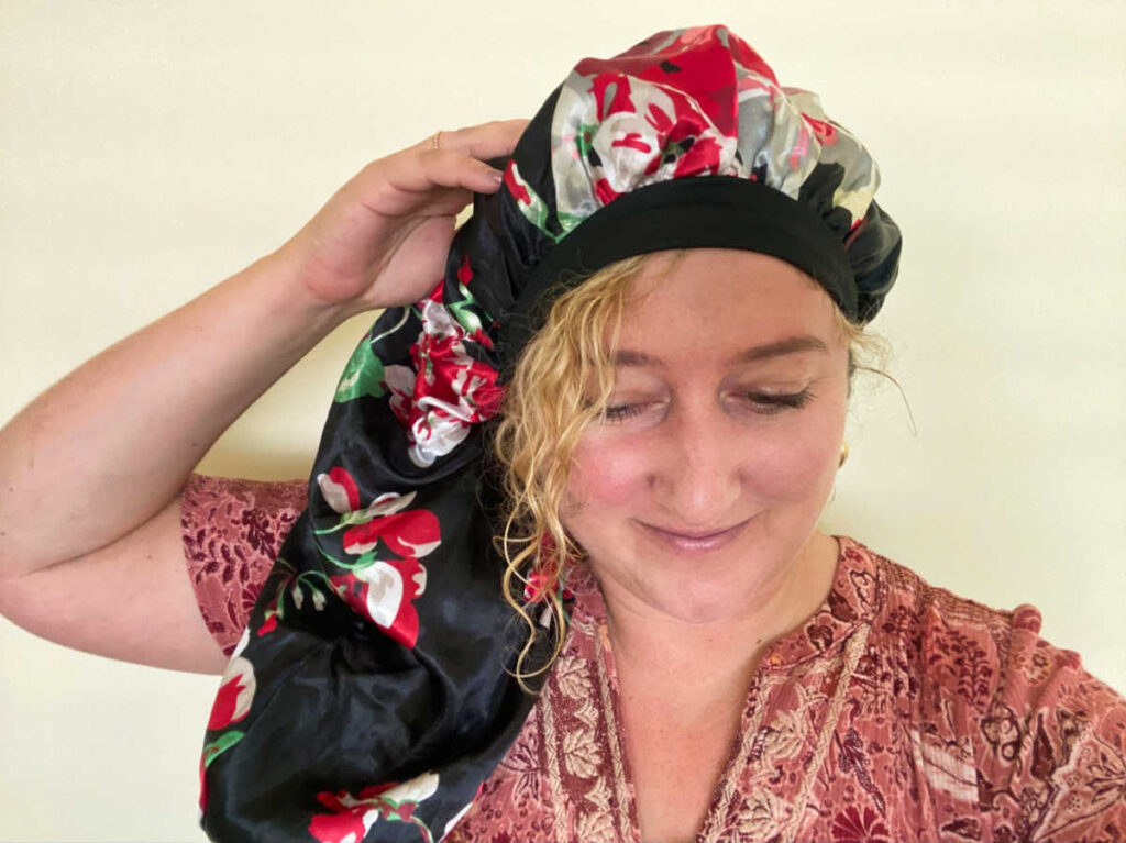 The author Jess Levy wearing a sleep bonnet for her hair