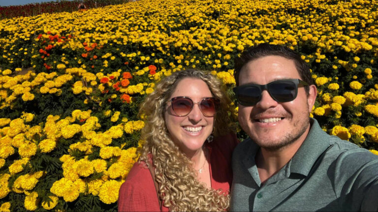 Travel Lemming author Jess and her date takes a selfie in a flower field in Carlsbad Strawberry Company