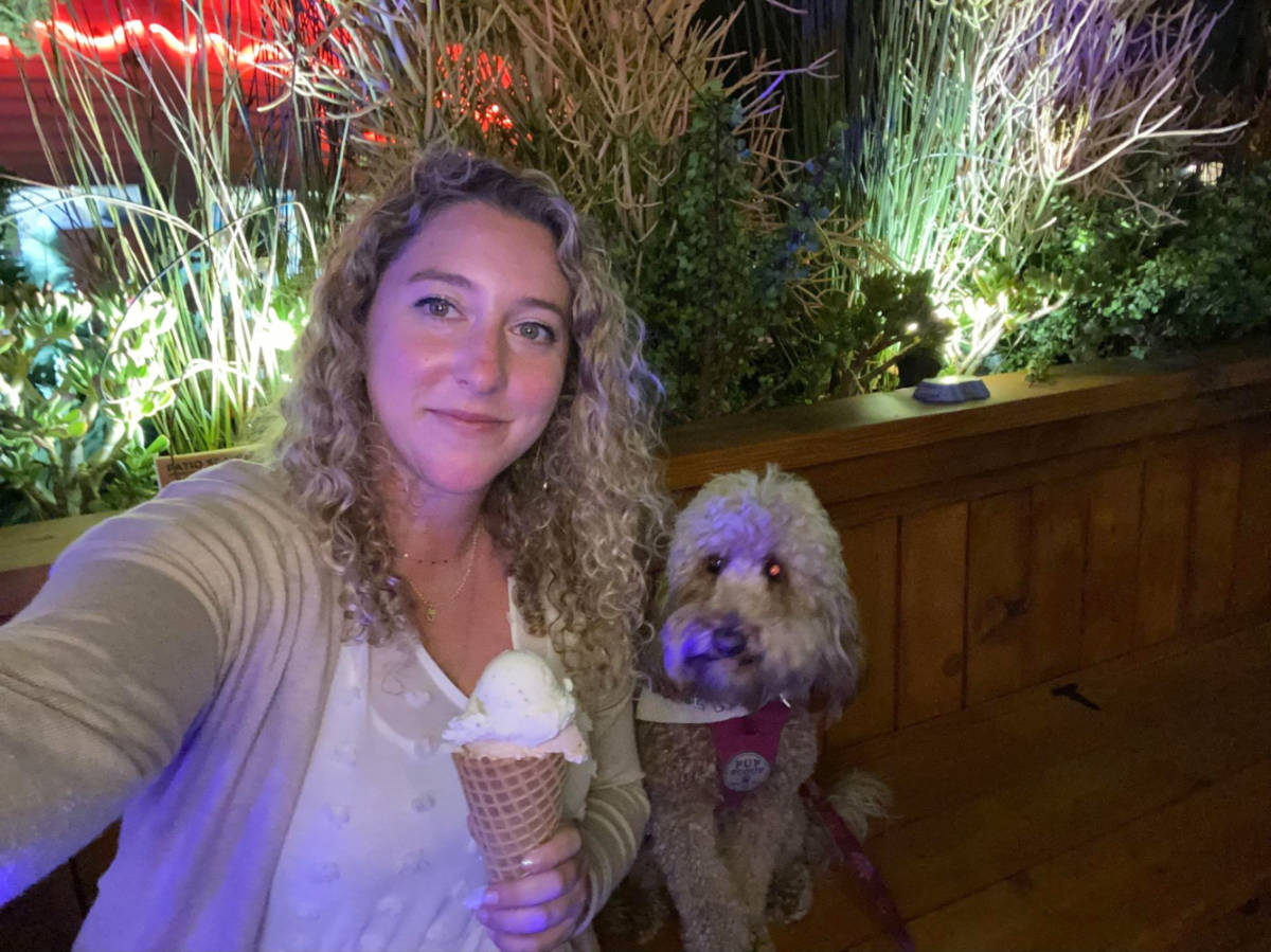 The author Jess holding a cone of gelato with her dog at the Gelato101