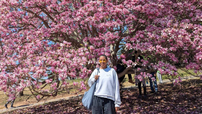 The author, Jonaye Barnum smiling for a photo during spring season in Maymont