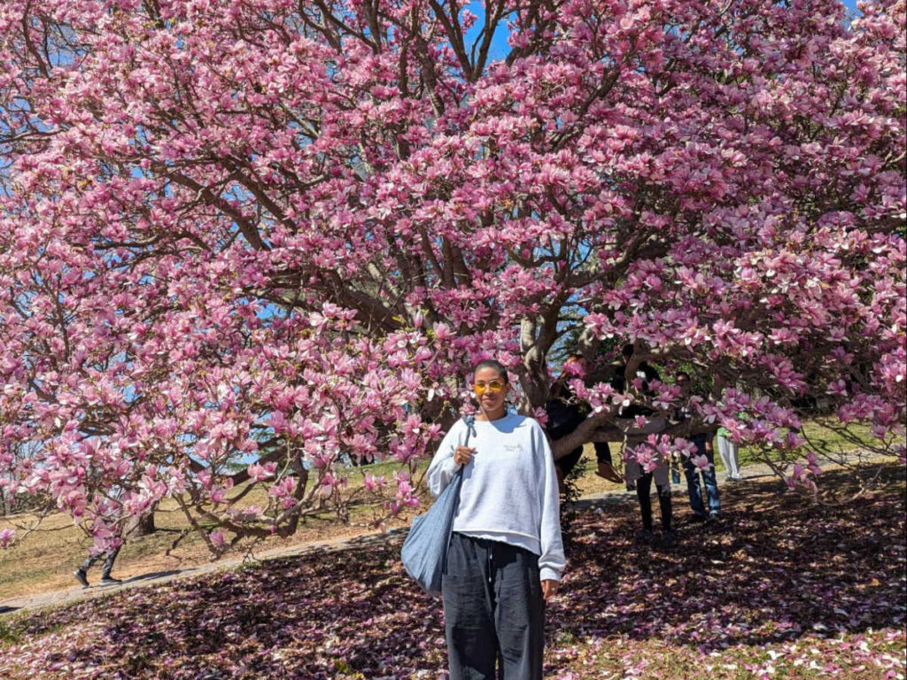 The author, Jonaye Barnum smiling for a photo during spring season in Maymont