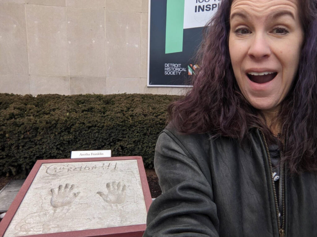 The author Julie Ballantyne Brown, starstruck in front of the handprints of Aretha Franki