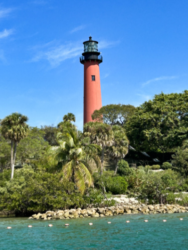 The Jupiter Inlet Lighthouse in the middle of the greenery seen from the ocean