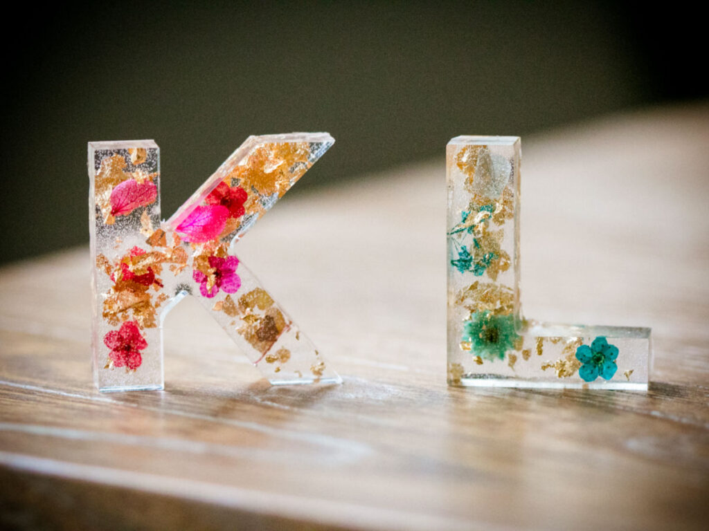Letters K and L with flowers preserved in resin