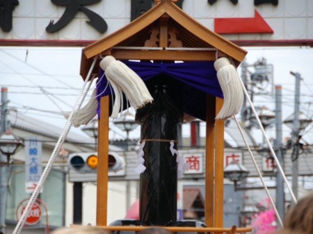 A mikoshi shrine with its phallus being paraded during the festival