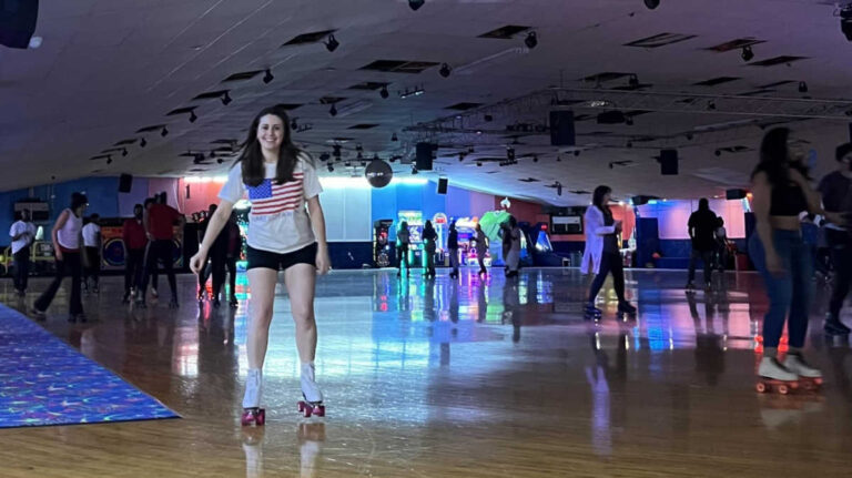 The author Kara Walters roller skating with the crowd at Winnwood Skate Center