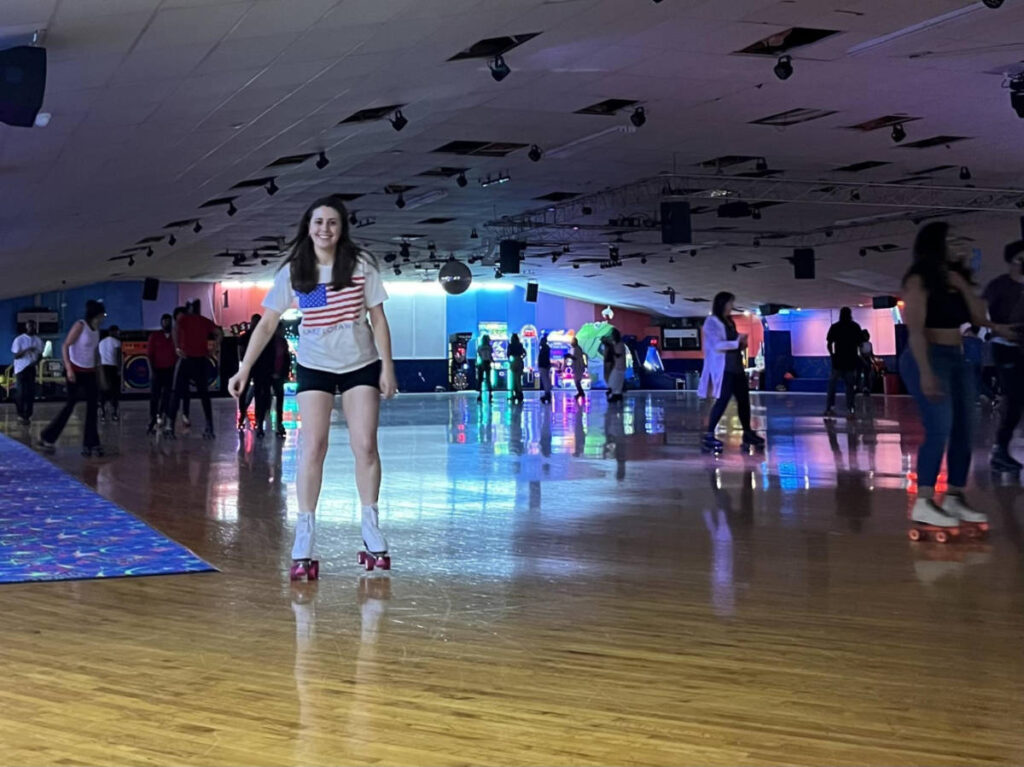 The author Kara Walters roller skating with the crowd at Winnwood Skate Center