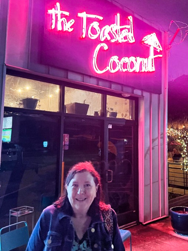 The author Karen Smith smiling outside The Toasted Coconut