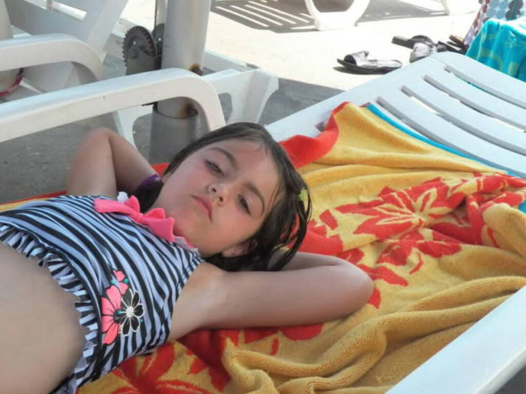 The author's granddaughter lying in the lounging chair