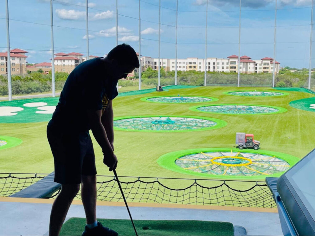 The author's son playing golf at Top Golf