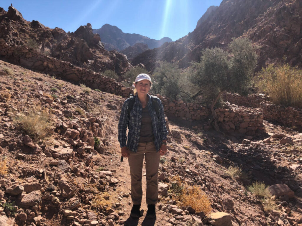 The author Kate McMahon, hiking on a sunny day in Egypt