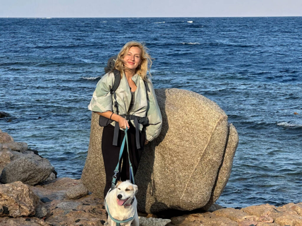The author Kate McMahon and her dog by the beach
