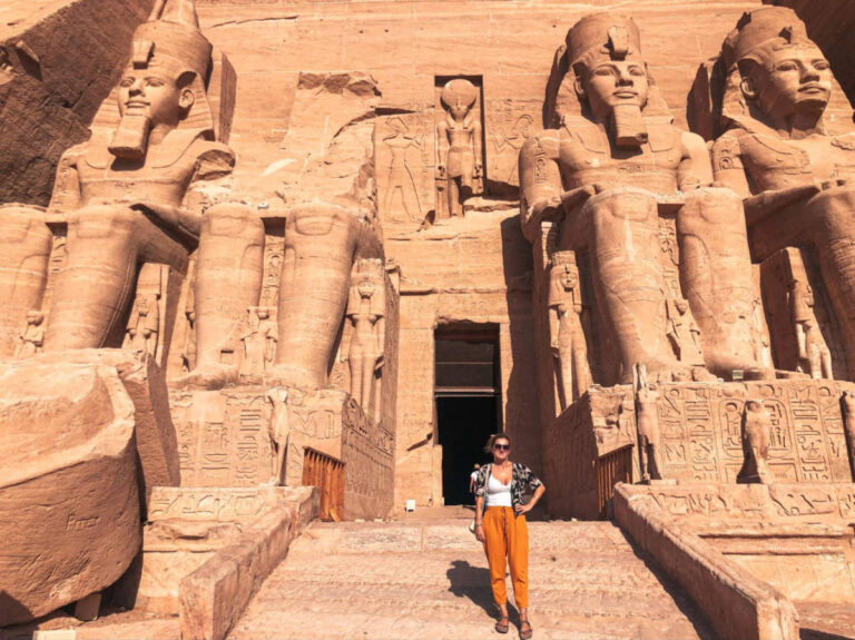 The author Kate McMahon, posing for a photo outside a Abu Simbel Temples in Egypt
