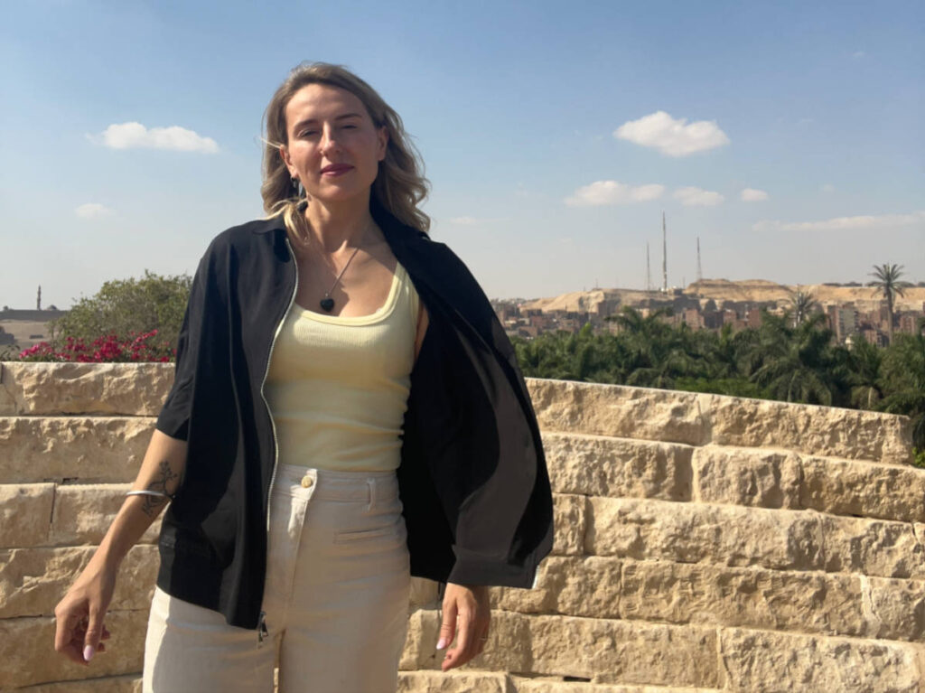 The author Kate McMahon, wearing a zippered coverup on a windy day in Cairo