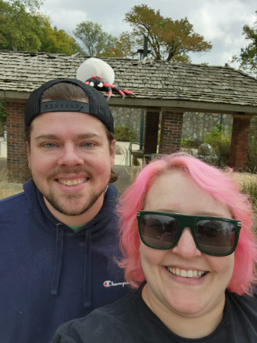 The author Kelsey Nighthawk and her husband posing for a photo at the Holliday Park
