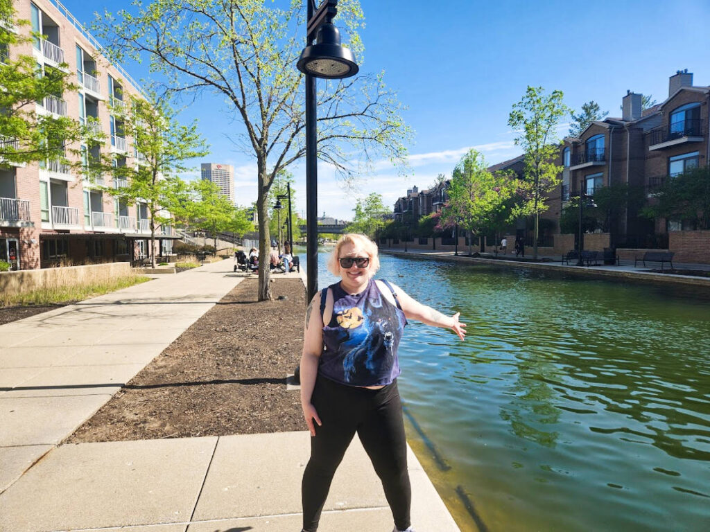 The author Kelsey Nighthawk posing for a photo at the Canal Walk