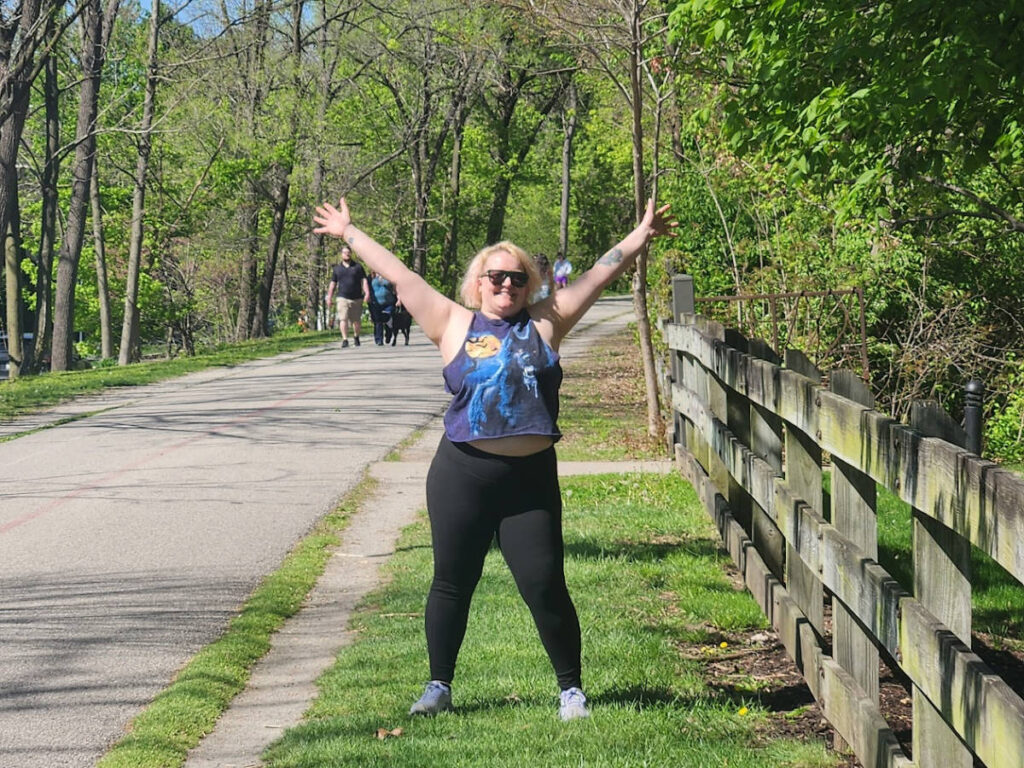 The author Kelsey Nighthawk posing for a photo by the Monon in Broad Ripple