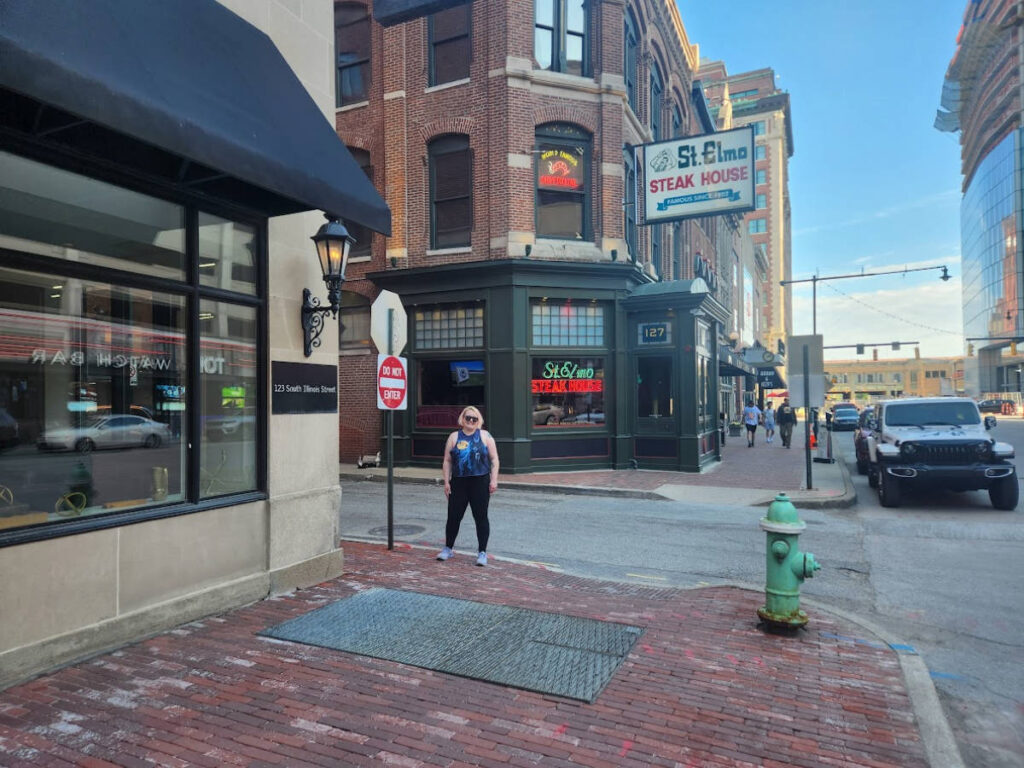 The author Kelsey Nighthawk posing for a photo at the famous St. Elmo sign