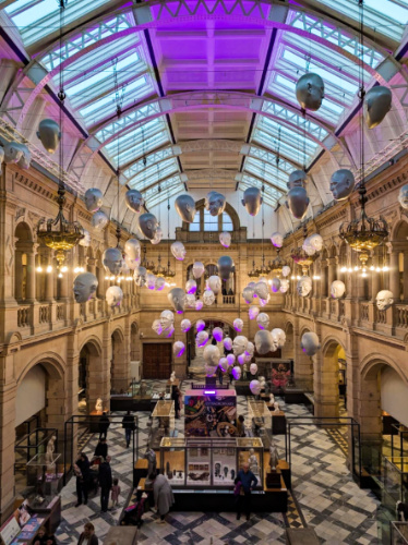 View of the floating head art pieces over the main gallery of Kelvingrove Art Gallery and Museum
