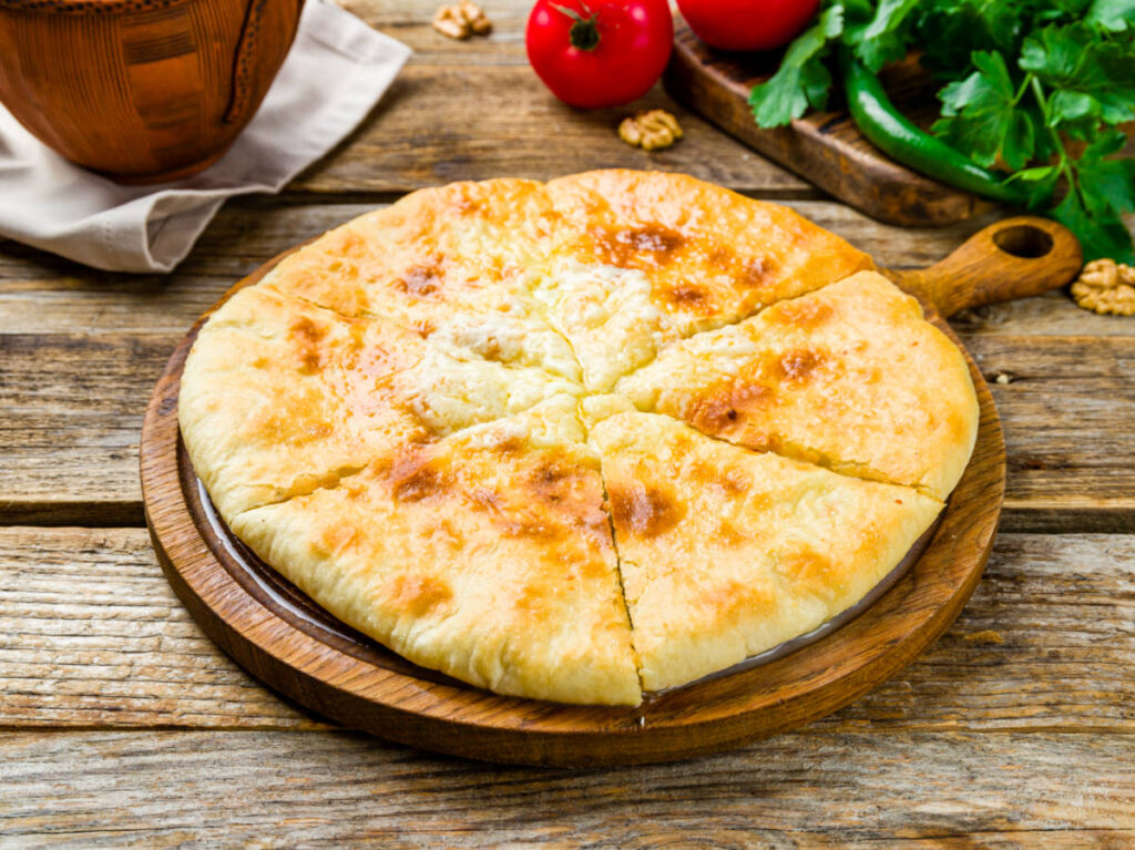 Closeup look of the Khachapuri cheese on a wooden board