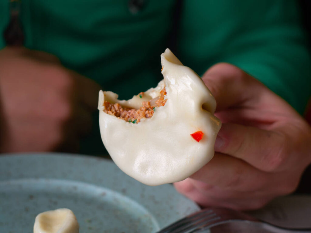 A hand holding a Khinkali