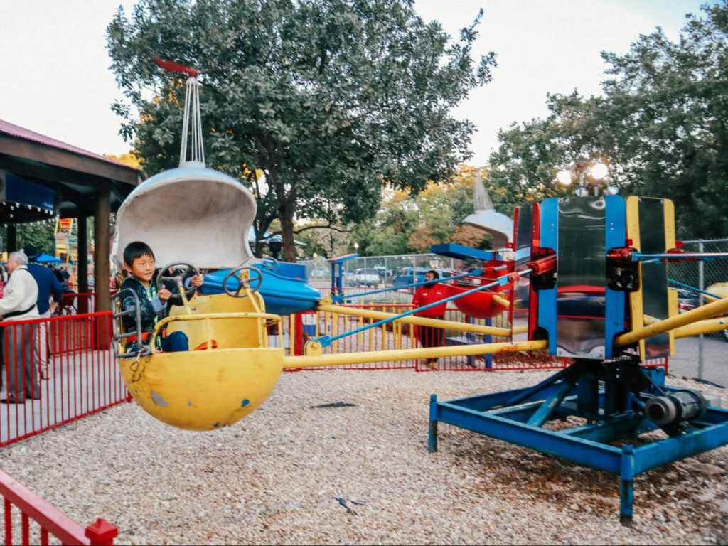 A kid enjoying the rides at Kiddie Park San Antonio