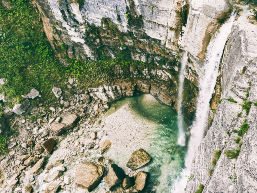 Aerial view of the Kinchkha Waterfall surrounded by rocks