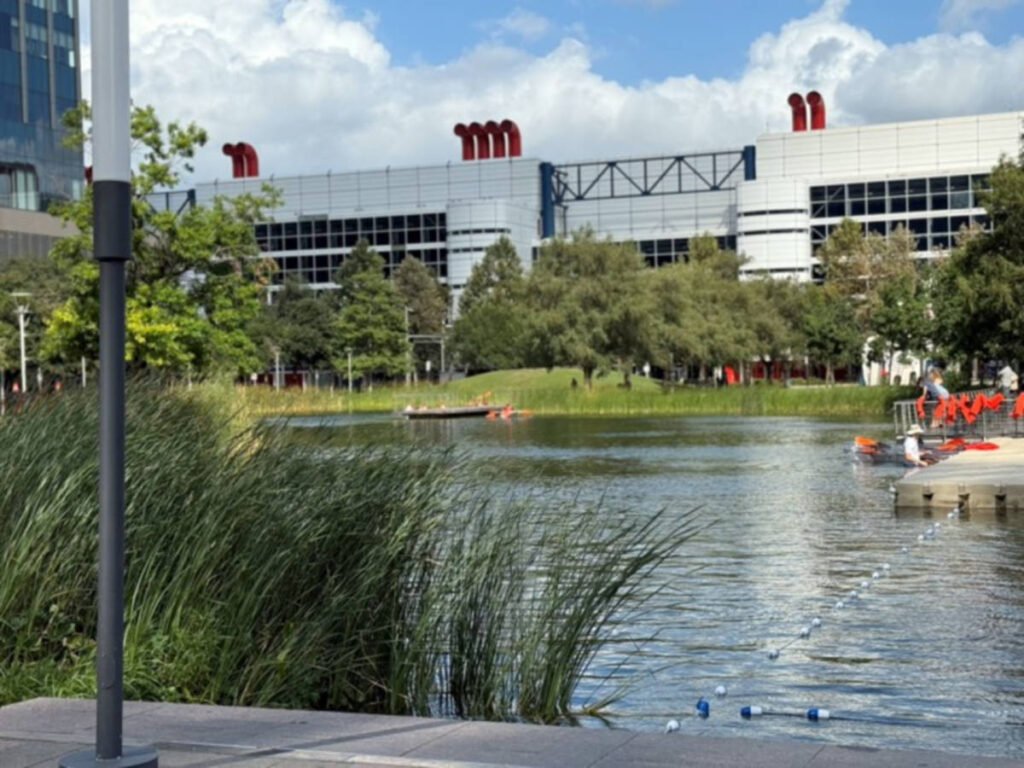 View of the Kinder Lake surrounded by greenery at Discovery Green