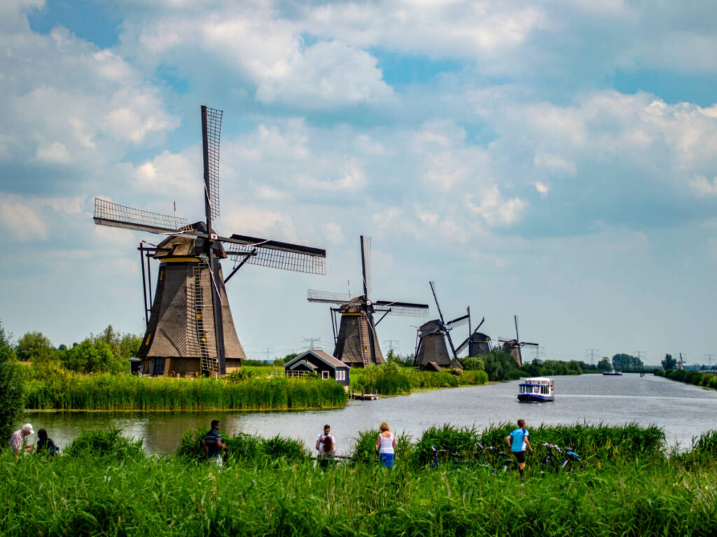 People cycling and admiring the view around the Kinderdijk mills