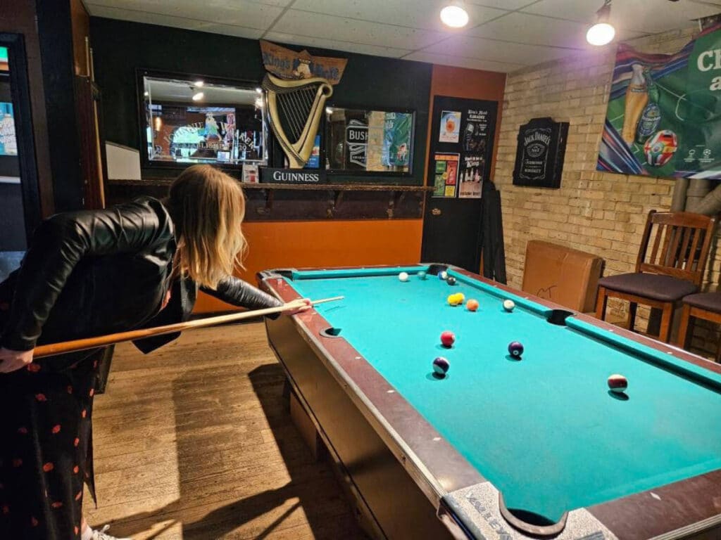The author, Taylor Herperger playing billiards with her friends at King’s Head Pub