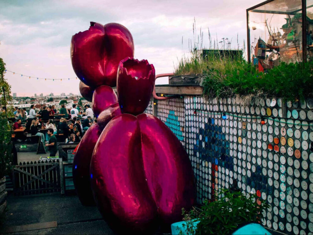 View of the crowd and the huge balloon-like dog art installation in Klunkerkranich