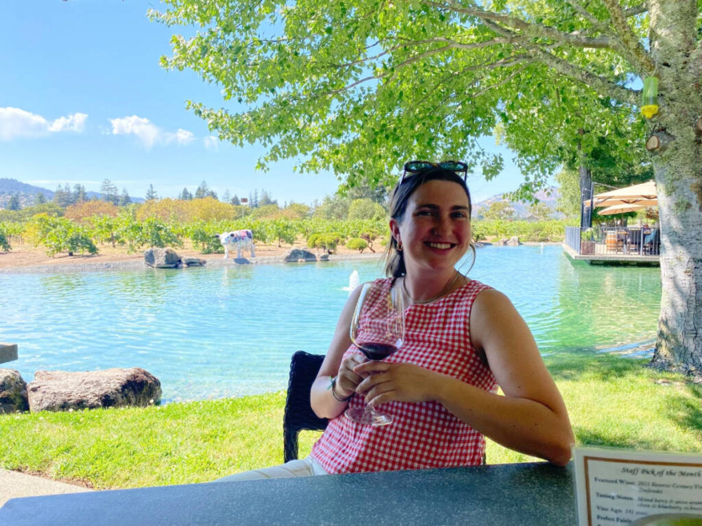 The author, Laura McFarland holding a glass of wine during her visit in Kunde Family Winery