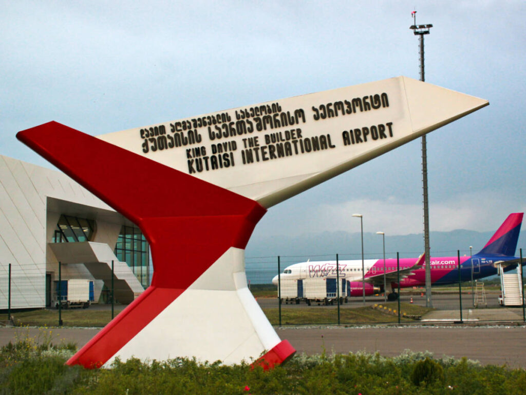 View of the plane behind the landmark at the Kutaisi International Airport